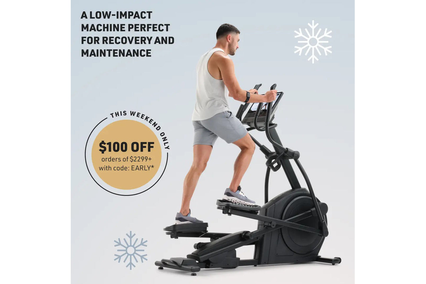 Man using black elliptical machine with handlebar controls, wearing white tank top and gray shorts, on light blue background