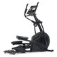 Black elliptical machine with curved handles, digital display console, and moving foot pedals on white background