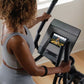 Person wearing gray sports bra using black NordicTrack AirGlide 7i elliptical with digital display screen