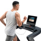 Man wearing light gray sleeveless tank top running on black NordicTrack treadmill with screen displaying fitness video