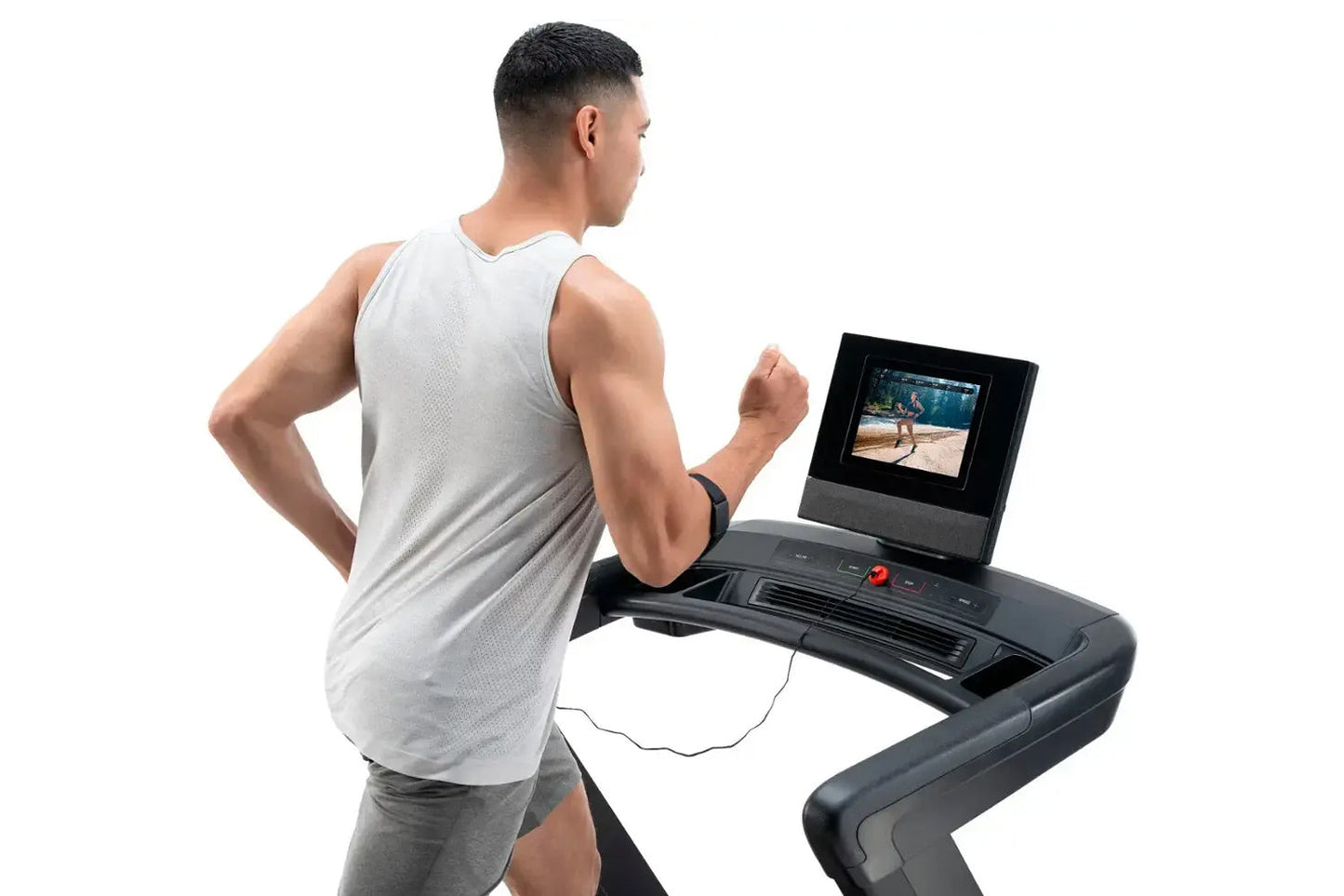 Man wearing light gray sleeveless tank top running on black NordicTrack treadmill with screen displaying fitness video