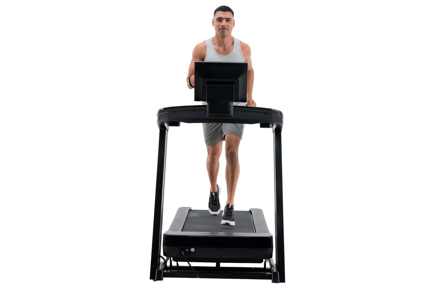 Man running on black NordicTrack Commercial 1250 treadmill with digital display, worn by model on white background