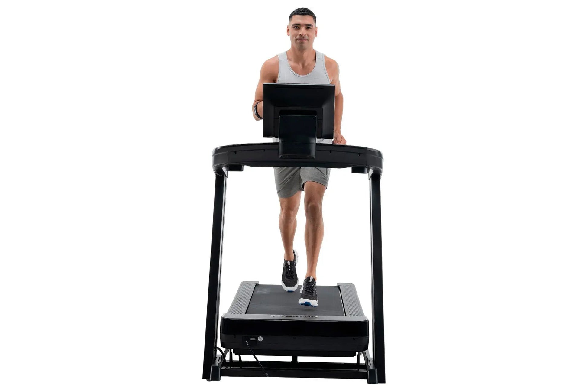 Man running on black NordicTrack Commercial 1250 treadmill with digital display, worn by model on white background