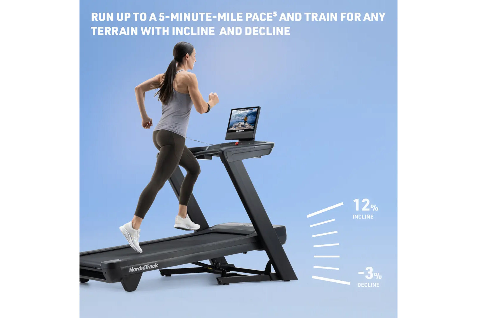 Woman running on black NordicTrack treadmill with touchscreen display showing incline and decline capabilities against blue b