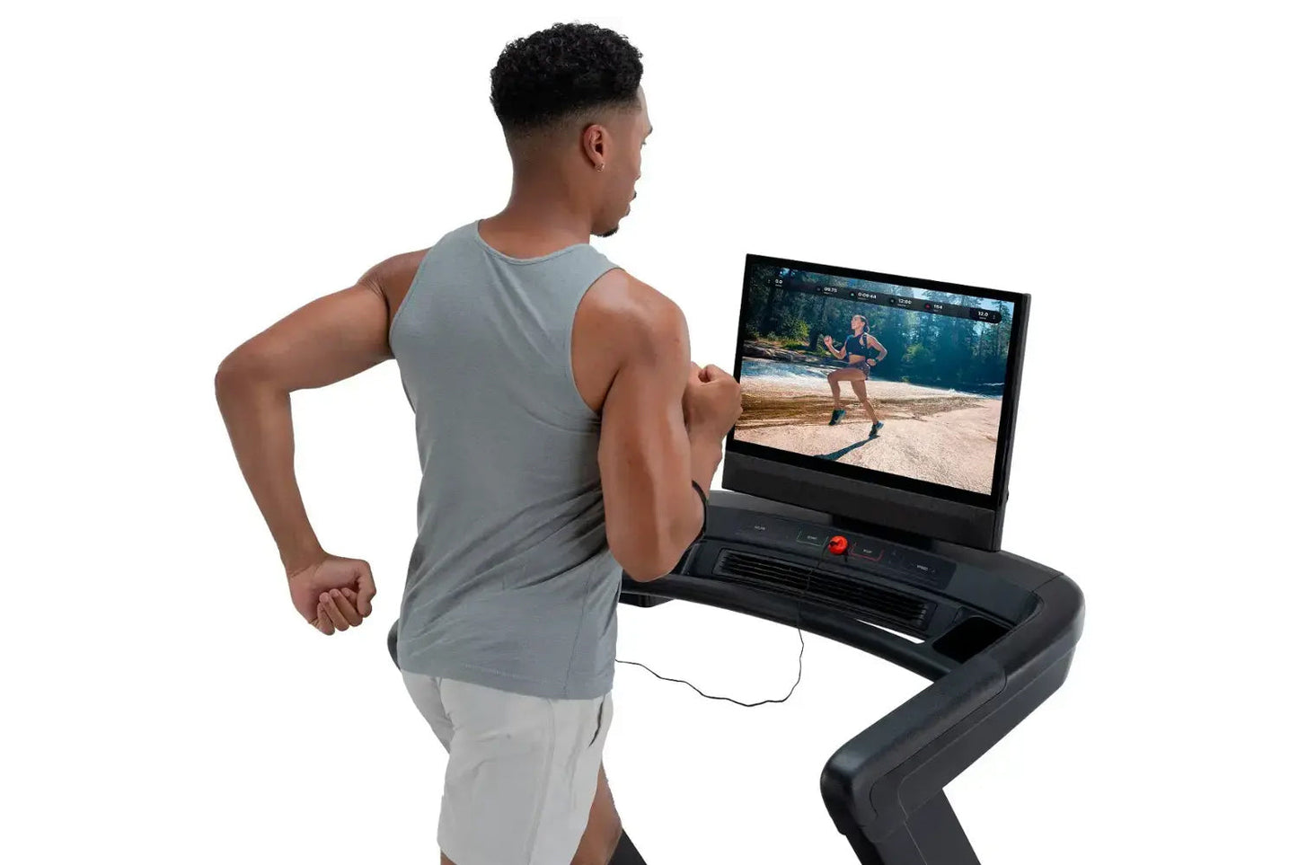 Man wearing gray sleeveless tank top running on black NordicTrack treadmill with display screen showing outdoor workout video