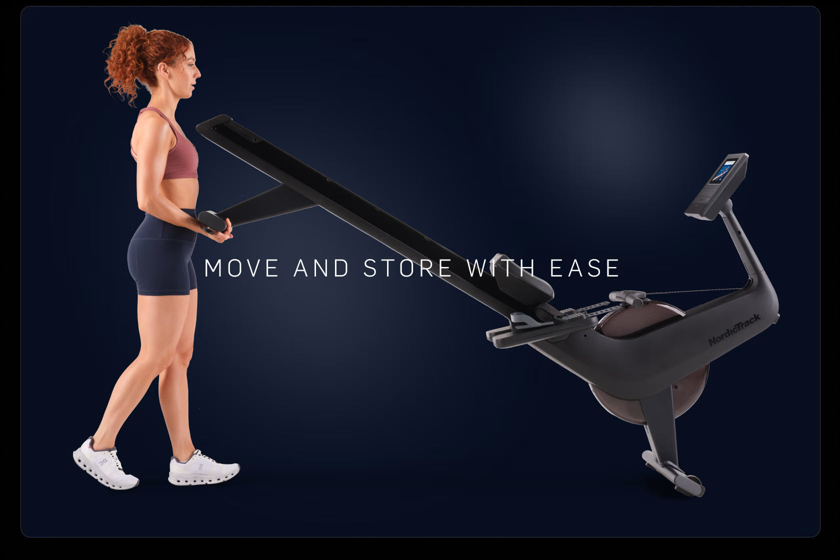 Woman with reddish hair wearing mauve sports bra and navy shorts using black NordicTrack stationary rowing machine on dark bl