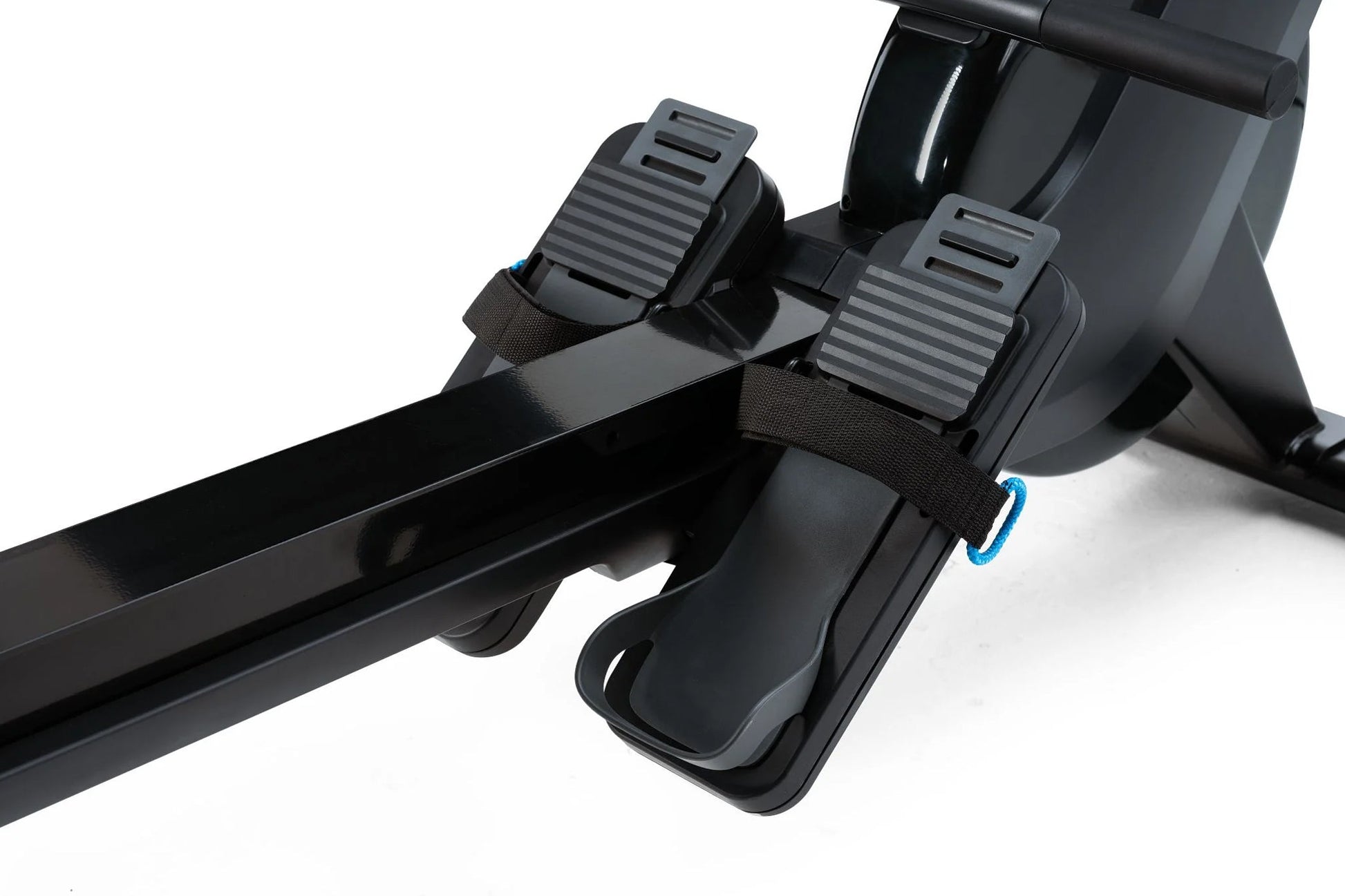 Black rower pedals with ribbed footplates and black straps with blue accents on white background