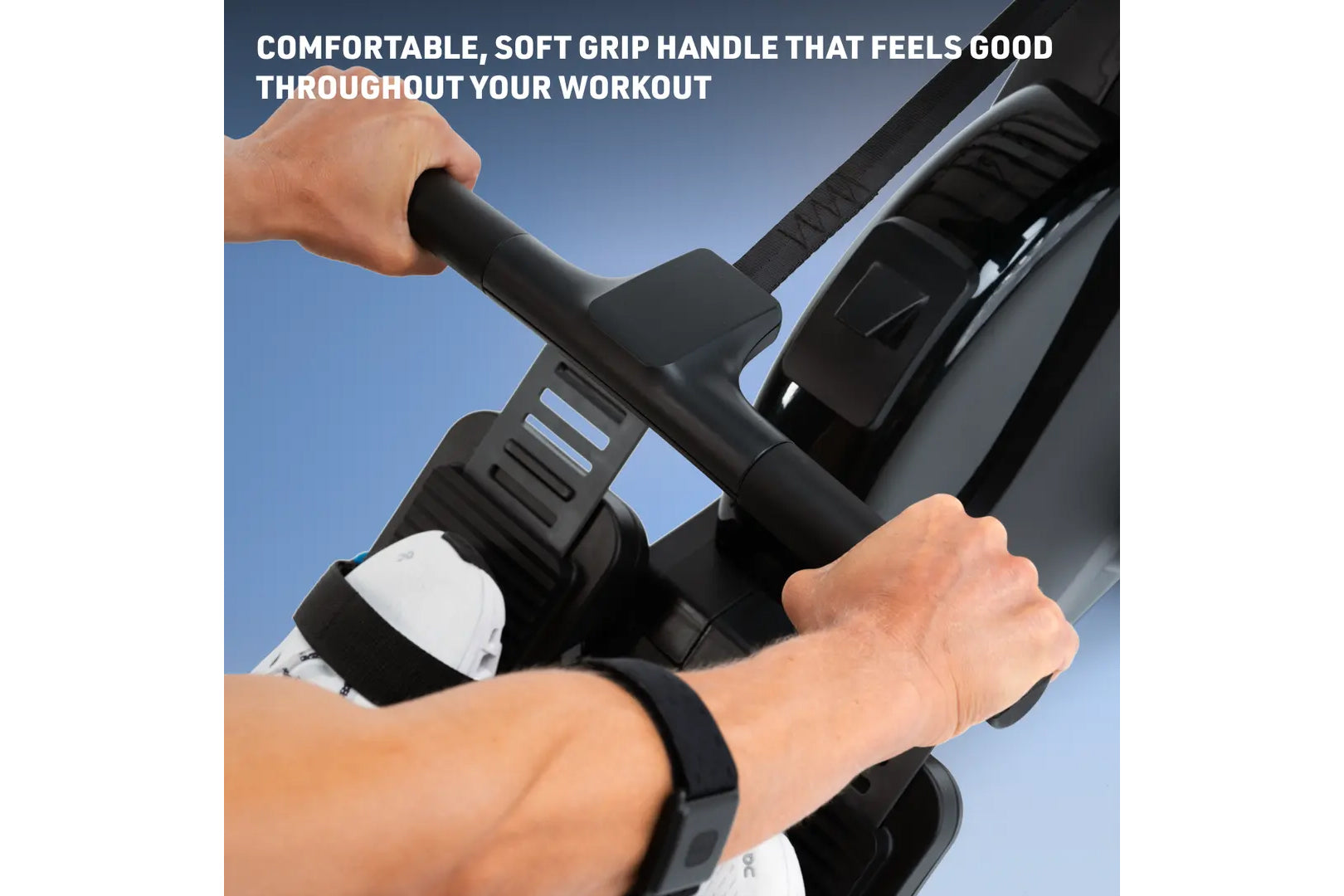 Close-up of hands gripping black soft-grip handles of NordicTrack rower machine against blue sky background