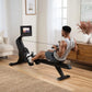 Black NordicTrack RW700 rowing machine with digital display, used by man in home living room