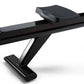 Black NordicTrack RW700 rowing machine with padded seat and angled footrest on white background