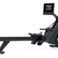 Black NordicTrack RW700 rowing machine with digital display monitor showing fitness video, featuring extended seat rail and f