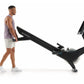 Man using black NordicTrack stationary rowing machine with digital display on white background