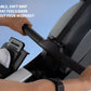 Hands gripping black soft-grip handle of rowing machine, worn by person in light gray shoe, against blue sky background