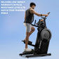 Man using black NordicTrack step climber with digital display, wearing charcoal tank top and white shorts, on blue background