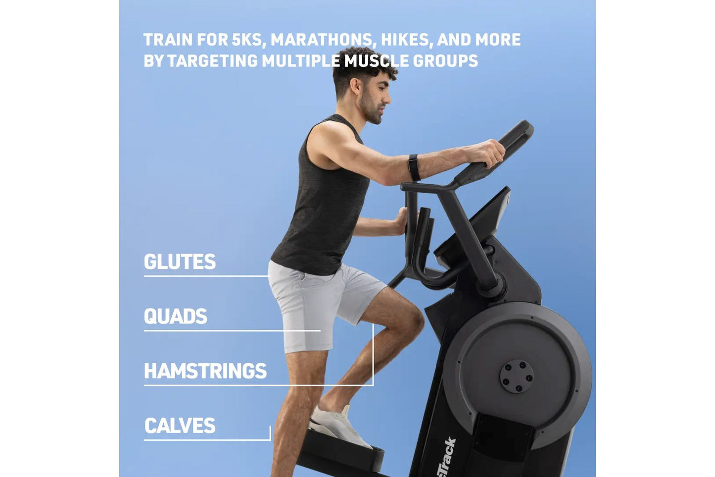 Man using black step climber machine against blue background, wearing black tank top and white shorts