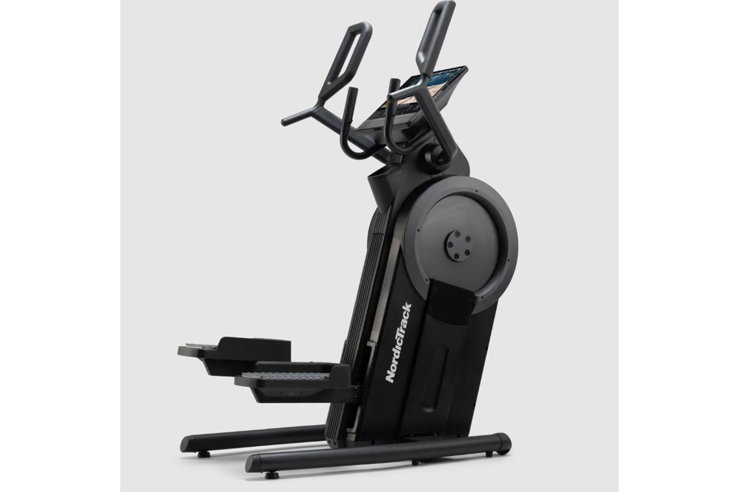 Black NordicTrack Step Climber XL with dual handlebars and large foot pedals on white background