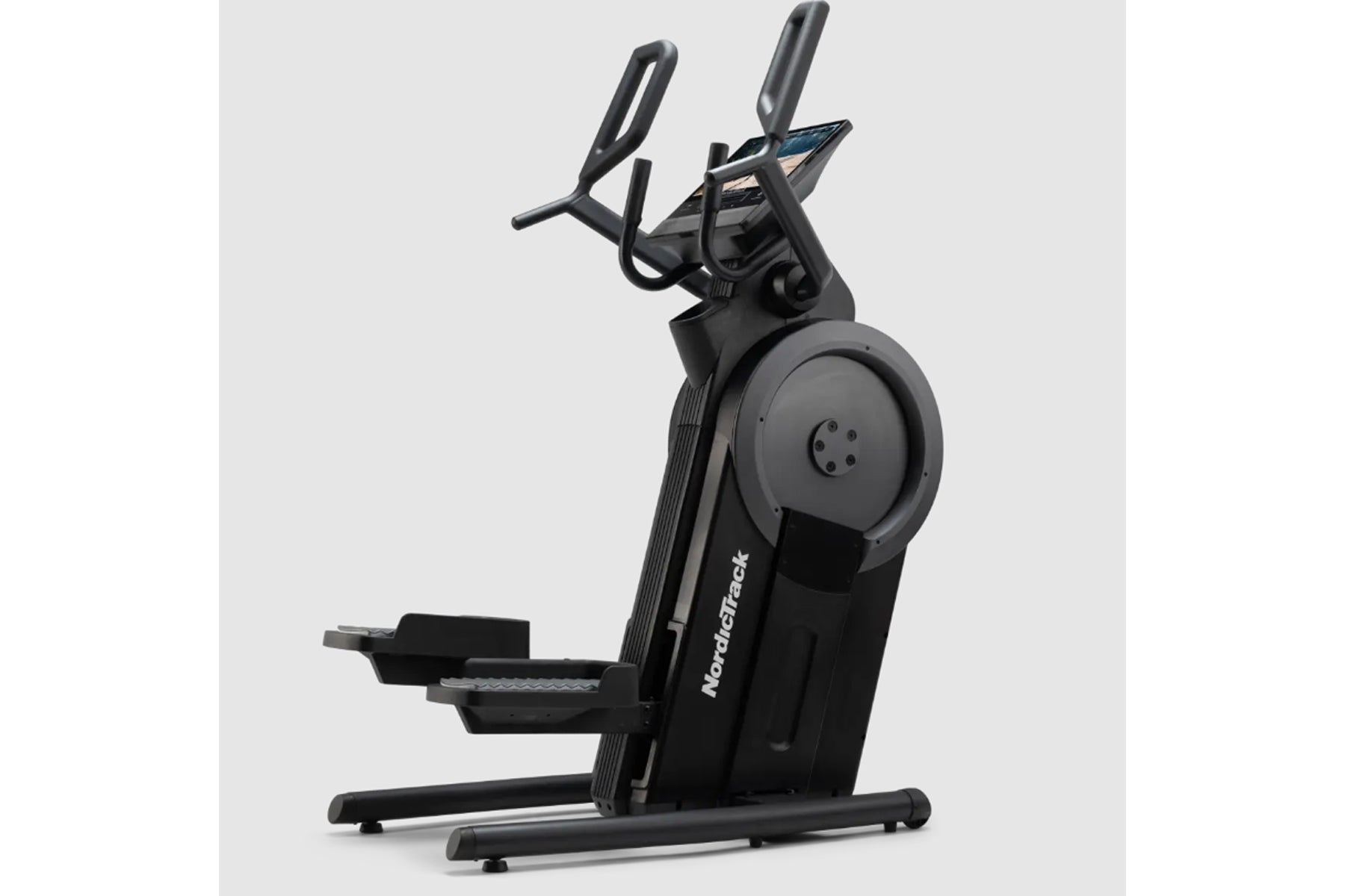 Black NordicTrack Step Climber XL with dual handlebars and large foot pedals on white background