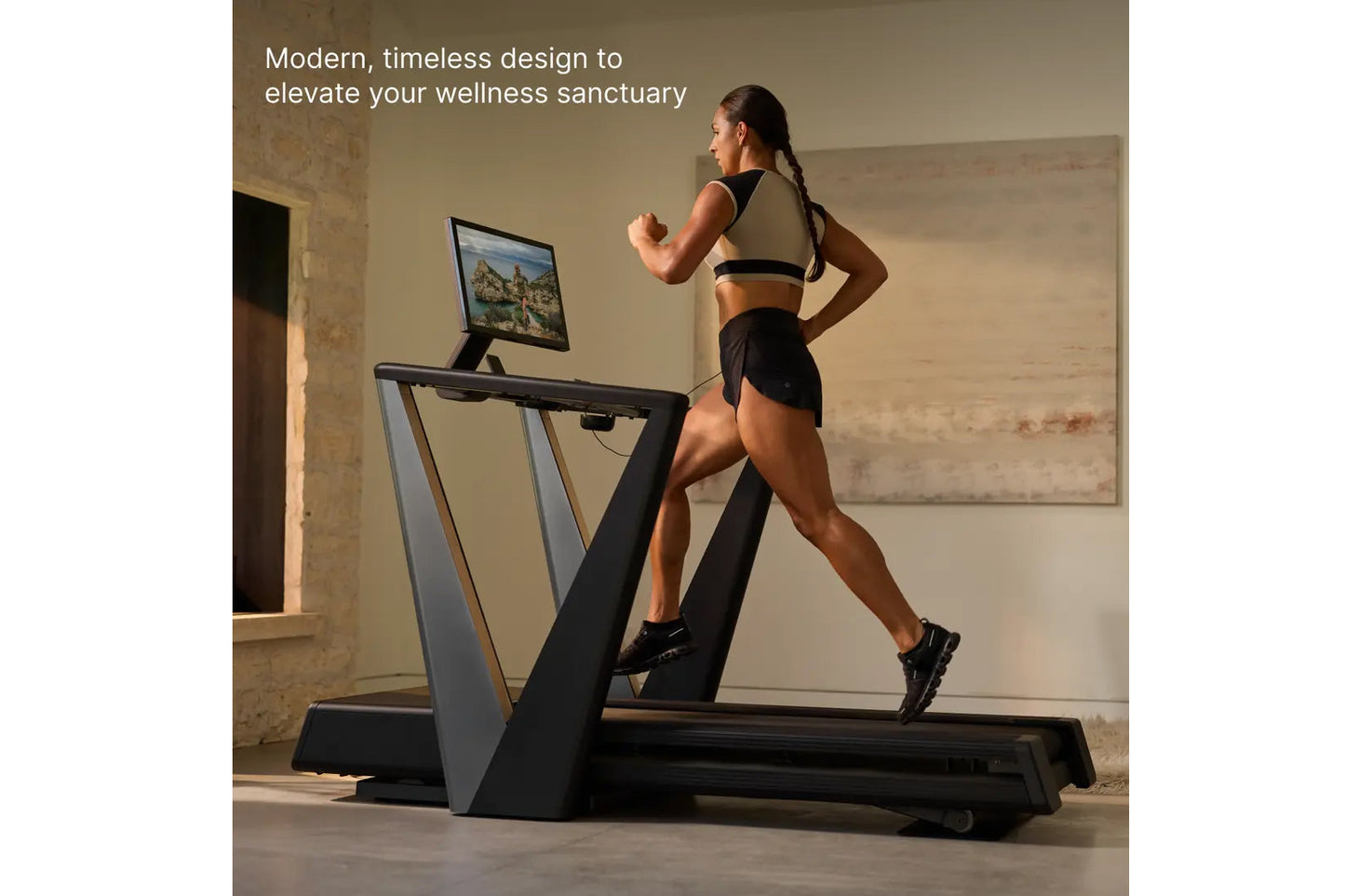 Woman running on black and gray modern treadmill with tablet display in minimalist room setting