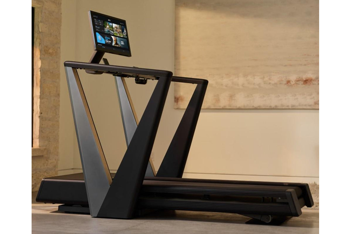 NordicTrack Ultra 3 treadmill with black frame and dual angled side rails, featuring mounted tablet display showing streaming