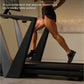 Person running on black NordicTrack treadmill with cushioned deck, indoor gym setting