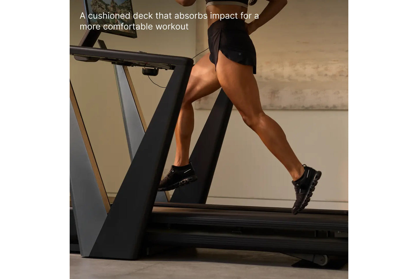 Person running on black NordicTrack treadmill with cushioned deck, indoor gym setting
