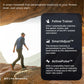 Man jogging outdoors on rocky terrain wearing blue jacket and cap, with smartphone displaying smart treadmill features includ