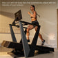 Woman running on black NordicTrack treadmill with monitor, wearing black sports bra and shorts