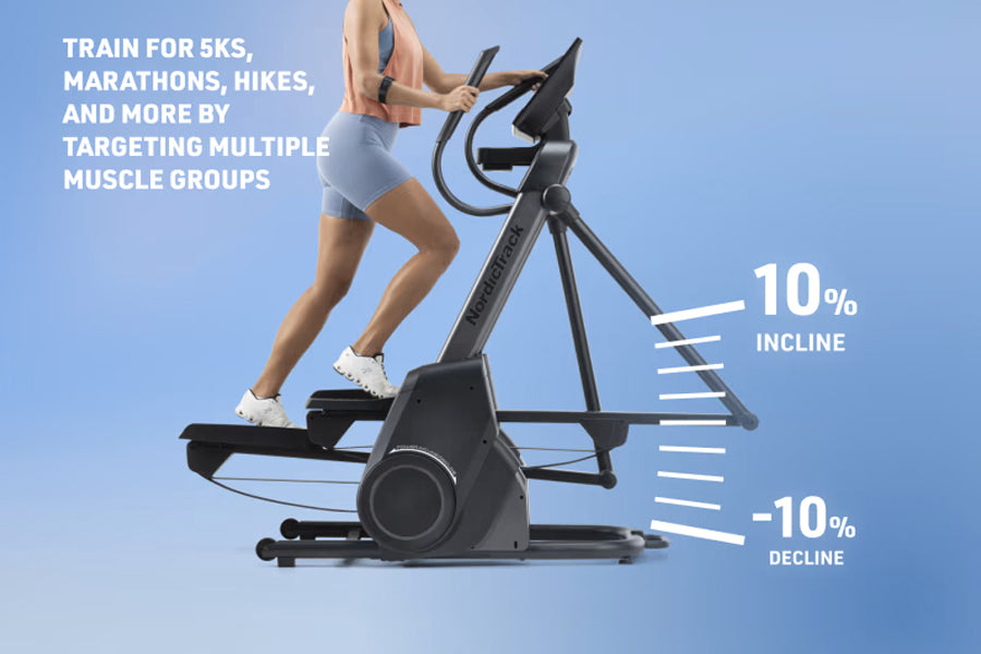 Woman wearing blue shorts and white sneakers using black NordicTrack X16 elliptical machine with 10% incline and -10% decline
