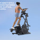 Woman using black 3-in-1 elliptical machine with digital display on blue background