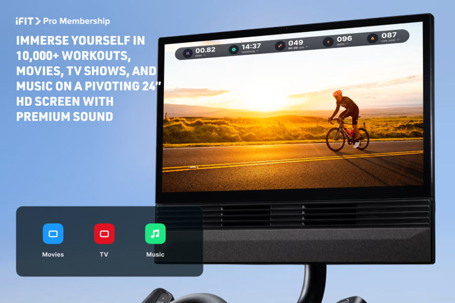 Black 24-inch HD monitor displaying iFIT Pro Membership content with cyclist on road, showing Movies, TV, and Music app icons