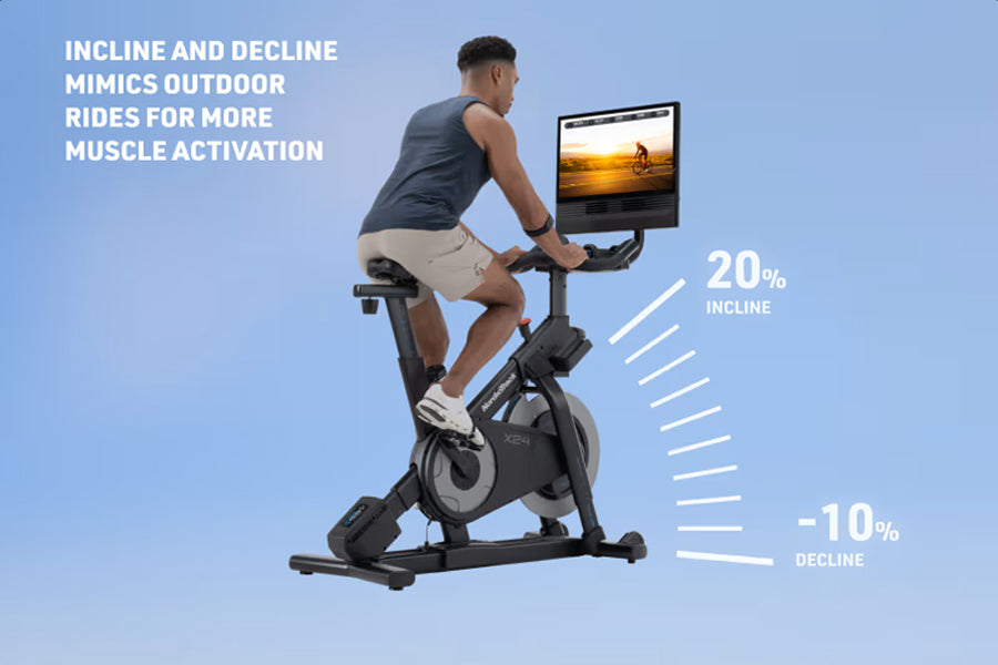 Man using black stationary exercise bike with screen displaying outdoor scenery, demonstrating incline and decline resistance