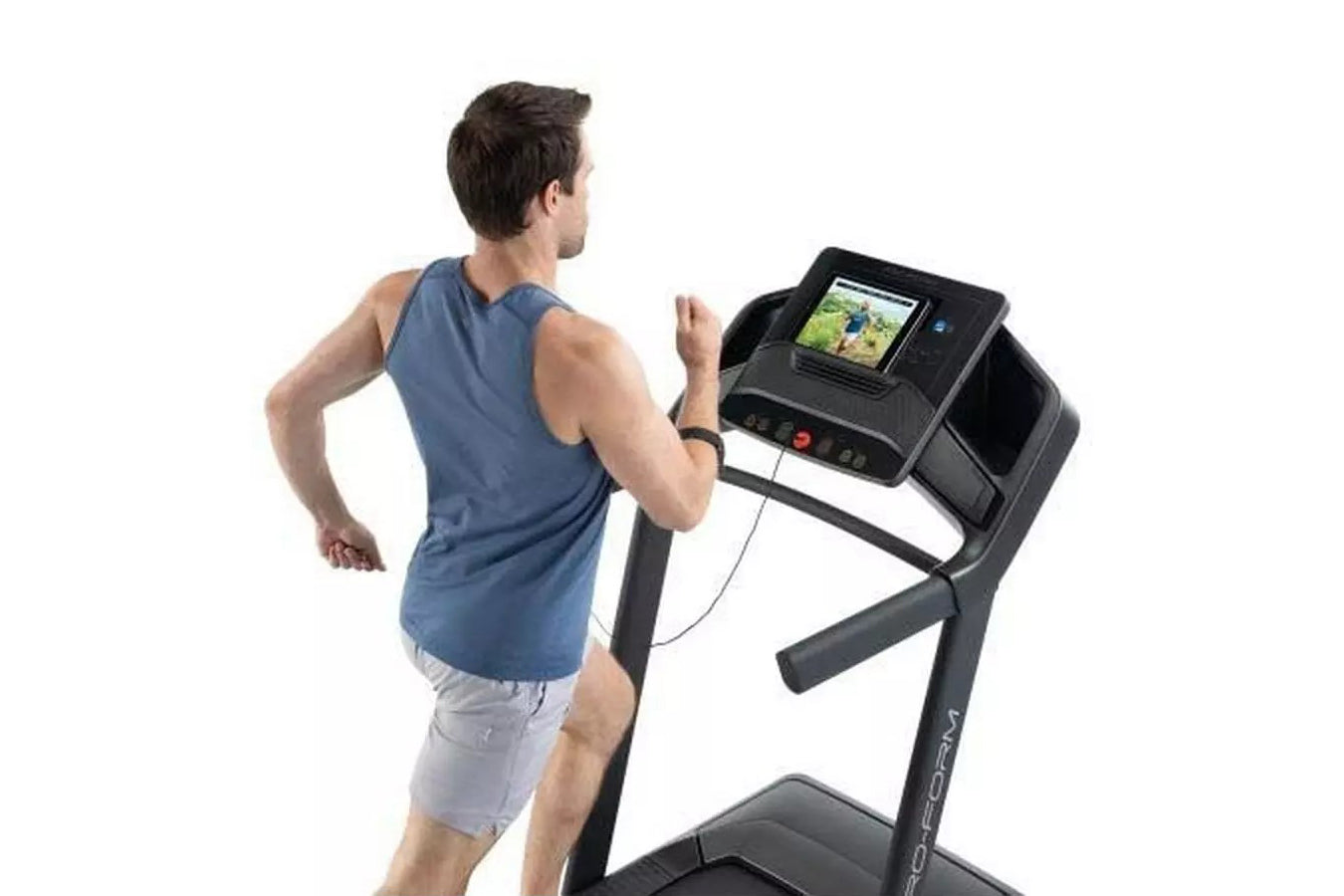 Man running on black ProForm treadmill with digital display, wearing blue sleeveless shirt and gray shorts