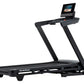 Black NordicTrack T-Series 10 treadmill with digital touchscreen console displaying workout content on white background
