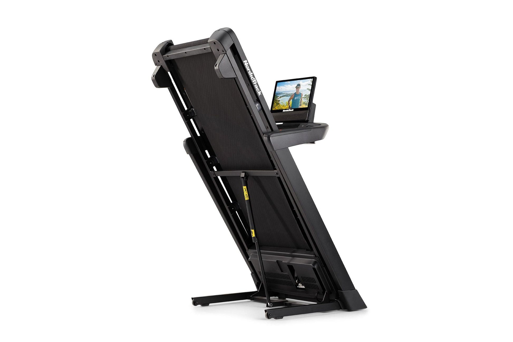Black folding treadmill with attached tablet holder displaying workout video, angled view on white background