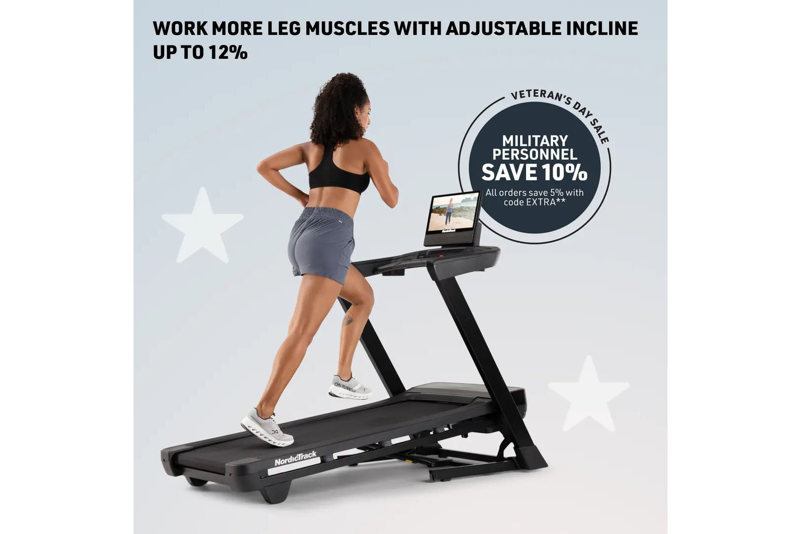 Woman running on black NordicTrack treadmill with tablet display, wearing black sports bra and gray shorts, on light blue bac