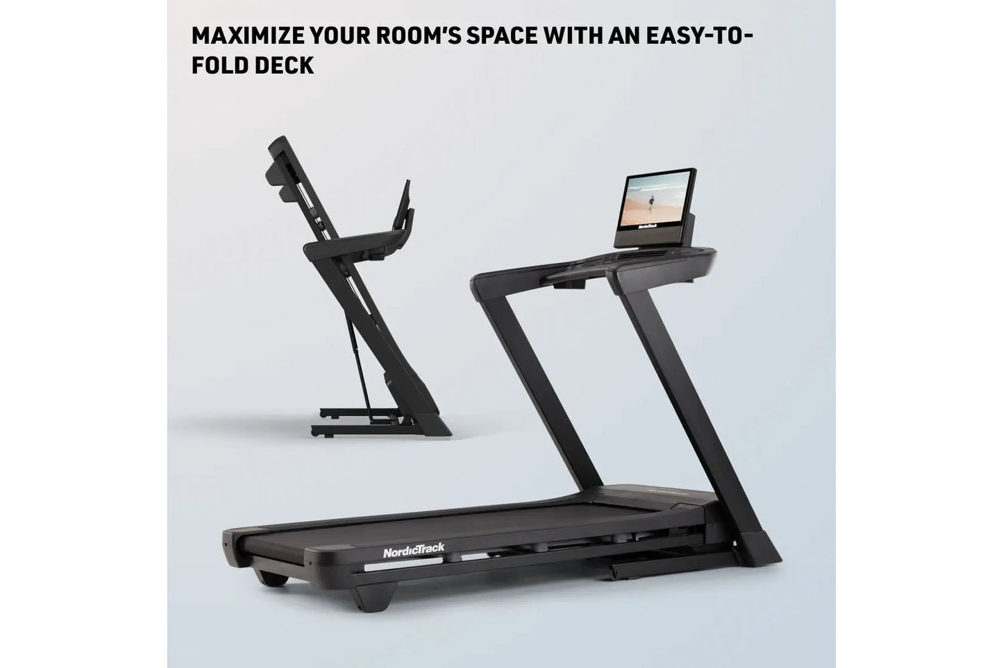 Black NordicTrack folding treadmill with tablet holder and stationary bike in background, displayed on white surface