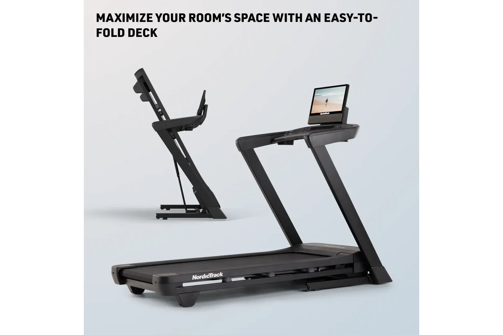 Black NordicTrack folding treadmill with tablet holder and stationary bike in background, displayed on white surface