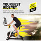 Man on black and yellow Nordictrack Tour de France indoor stationary bike with screen, wearing black shirt and shorts, with y
