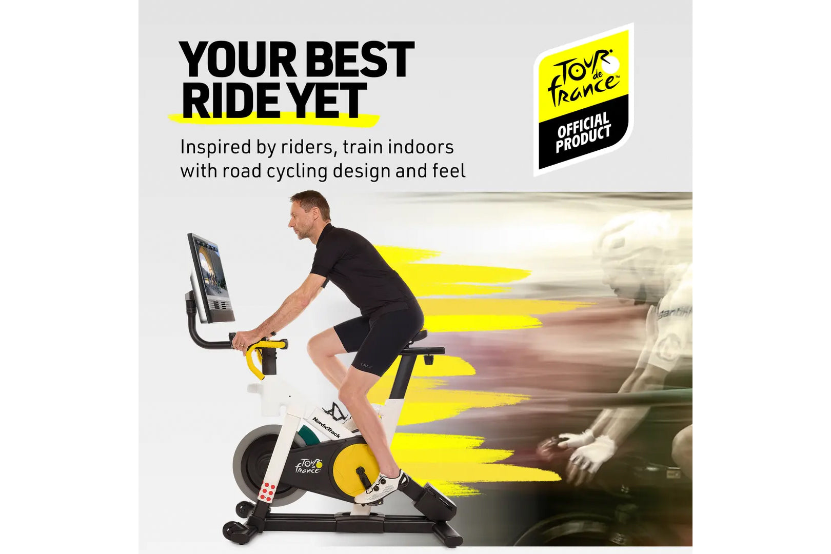 Man on black and yellow Nordictrack Tour de France indoor stationary bike with screen, wearing black shirt and shorts, with y