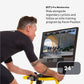 Man on stationary bike with yellow handlebars riding virtual cycling class on NordicTrack 24-inch screen displaying elite tra