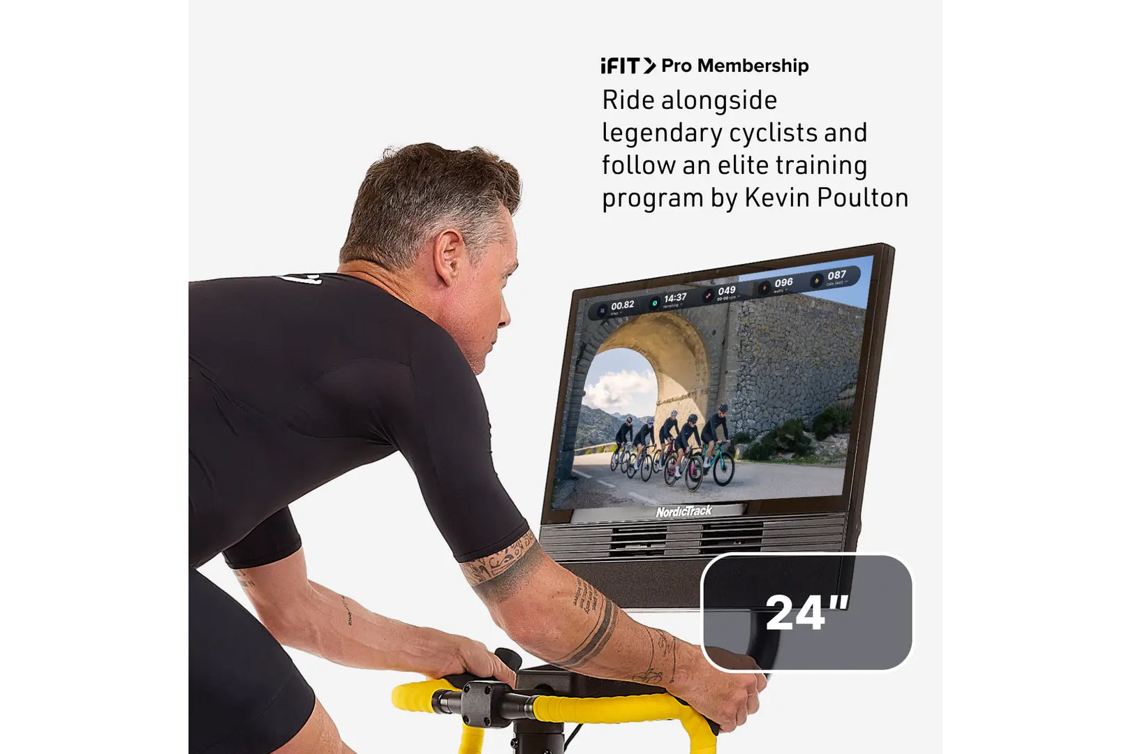 Man on stationary bike with yellow handlebars riding virtual cycling class on NordicTrack 24-inch screen displaying elite tra