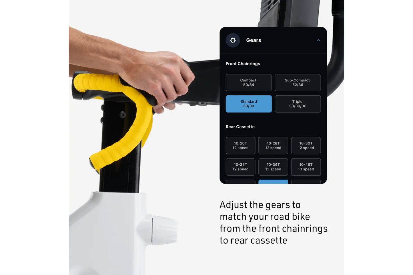 Hand gripping yellow handlebar of black stationary bike with gear adjustment menu displayed on screen