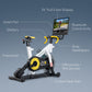 Nordictrack Tour De France stationary bike with white frame, yellow accents, and attached 24-inch display showing cycling vid