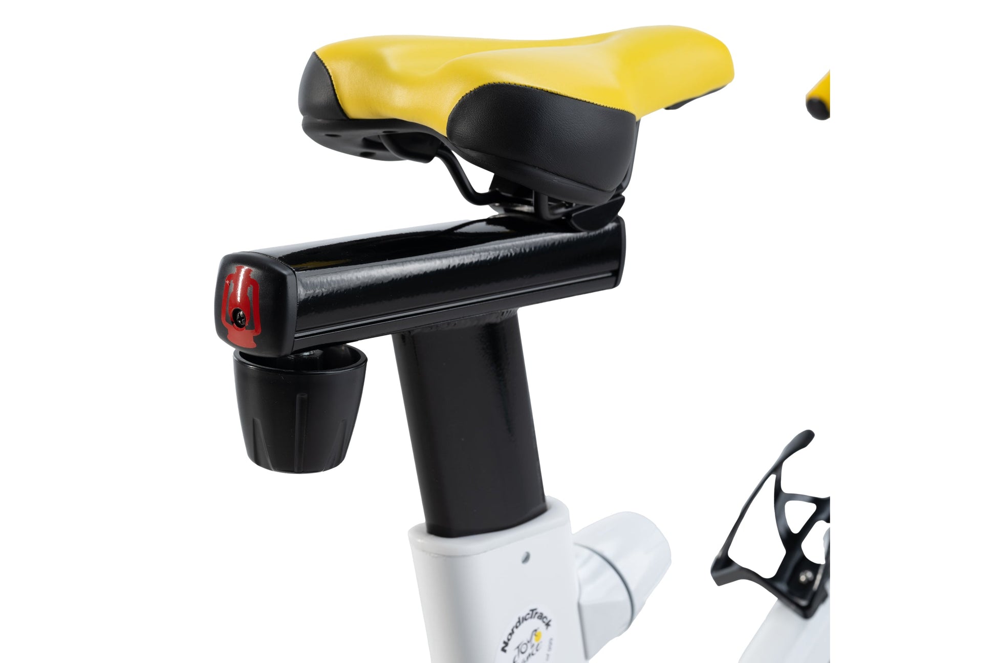 Yellow and black stationary bike seat mounted on white base with black frame, red tail light, and water bottle holder, shown 