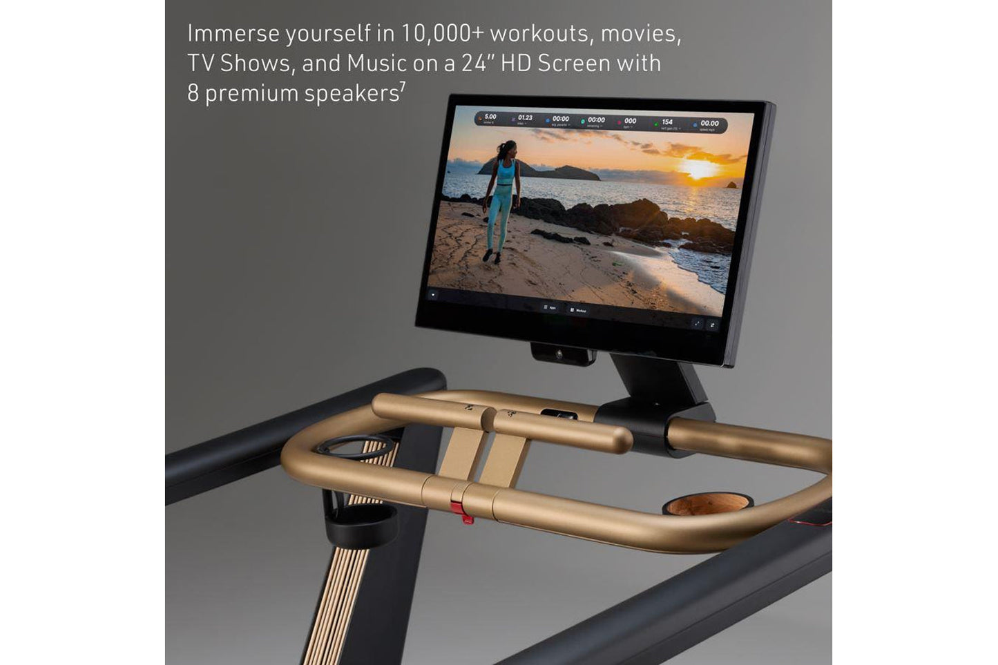 Exercise bike with gold and black handlebars displaying workout video on 24-inch HD screen mounted above