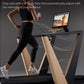 Woman running on treadmill with black deck and natural wood frame, tablet display mounted showing outdoor scene, air flow vis