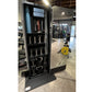 Black mirrored home gym cabinet with open door displaying storage shelves, dumbbells, and resistance bands in gym setting