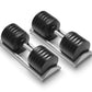 Pair of Nüobell adjustable dumbbells with black rubber heads and silver handles on gray base, flat lay on white background