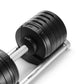 NÜOBELL adjustable dumbbells with black matte weight plates, white grip handle, and silver base on white background