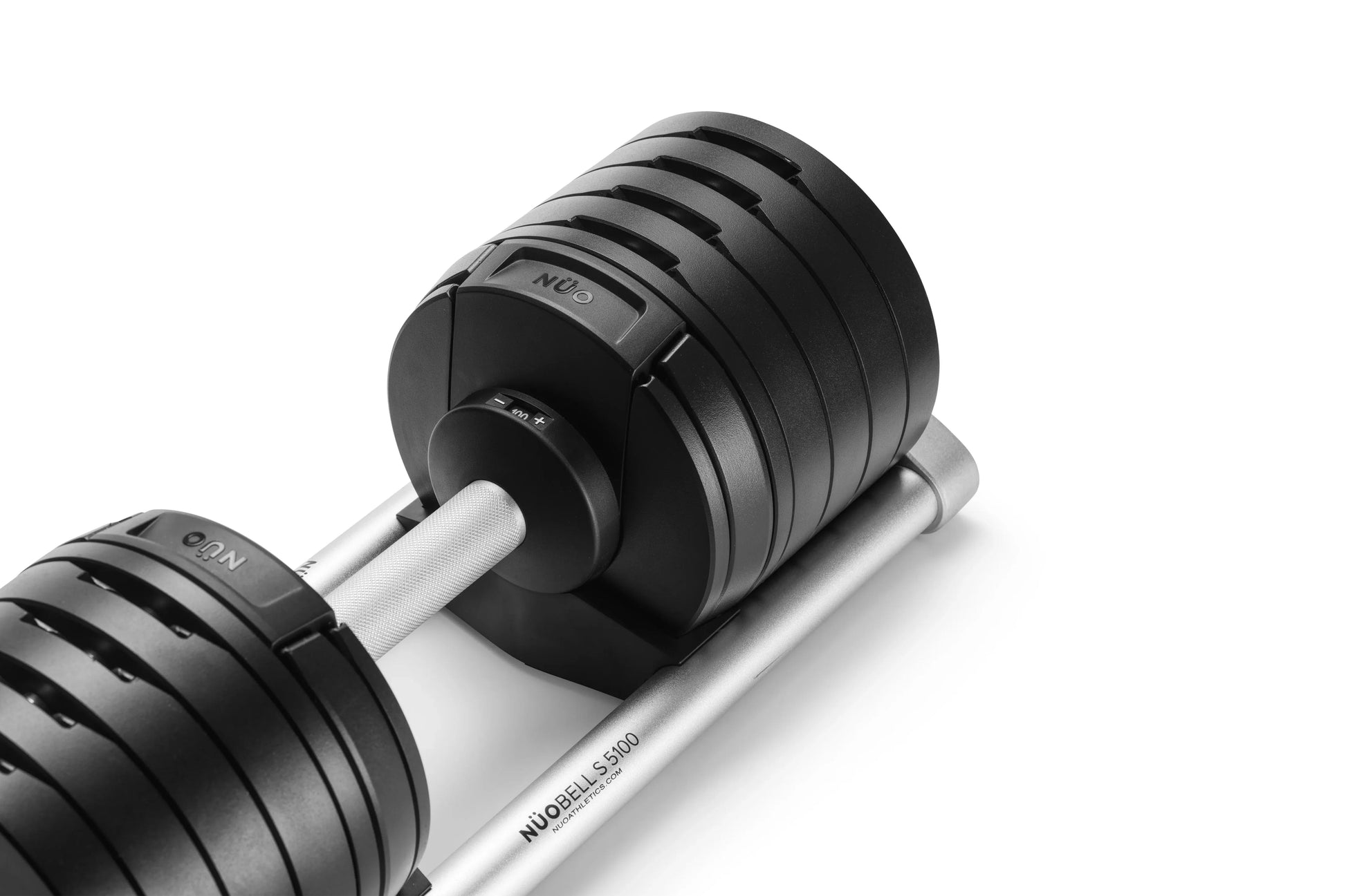 NÜOBELL adjustable dumbbells with black matte weight plates, white grip handle, and silver base on white background